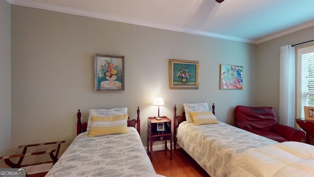 bedroom with crown molding and dark hardwood / wood-style floors