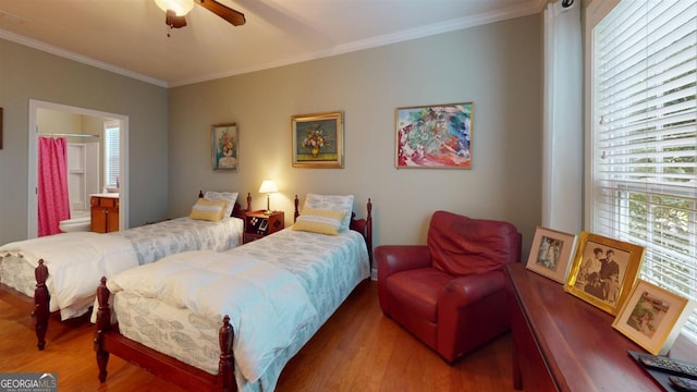 bedroom with hardwood / wood-style floors, ceiling fan, connected bathroom, and crown molding