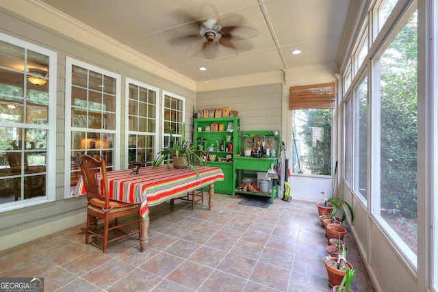 sunroom / solarium featuring plenty of natural light and ceiling fan