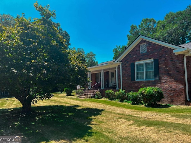 view of property exterior featuring a porch and a yard