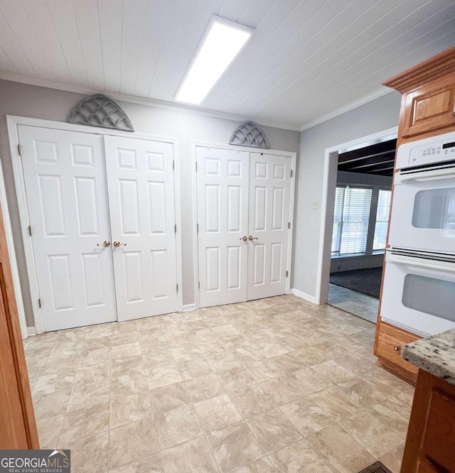 kitchen featuring white double oven and crown molding