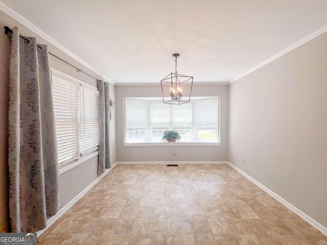 unfurnished room with a notable chandelier, baseboards, and crown molding