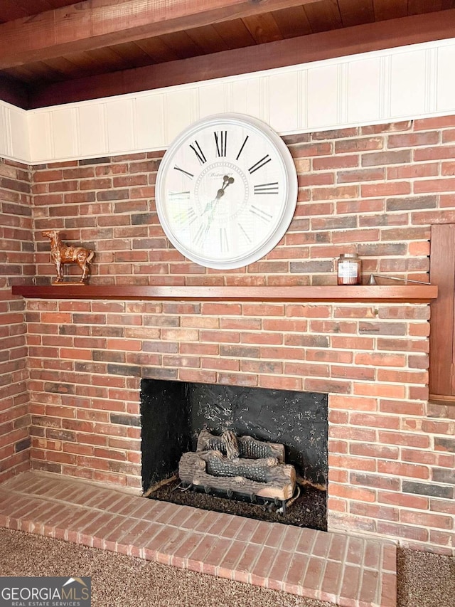 interior details featuring a fireplace, beamed ceiling, and wooden ceiling