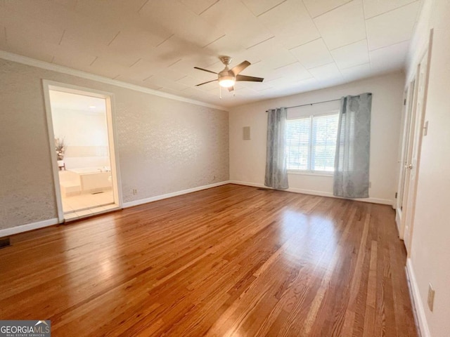 empty room featuring ornamental molding, hardwood / wood-style floors, and ceiling fan