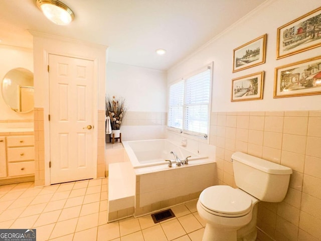 bathroom with toilet, tile patterned floors, crown molding, a relaxing tiled tub, and tile walls