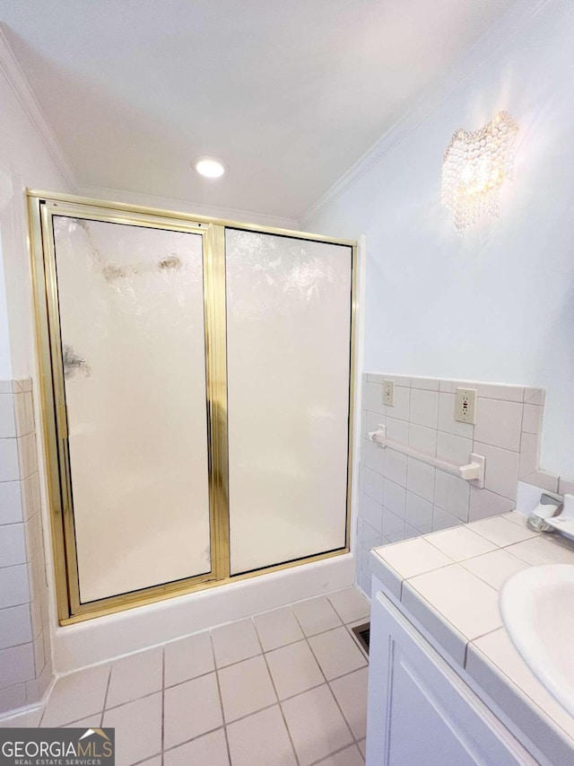 bathroom with tile patterned flooring, tile walls, and crown molding