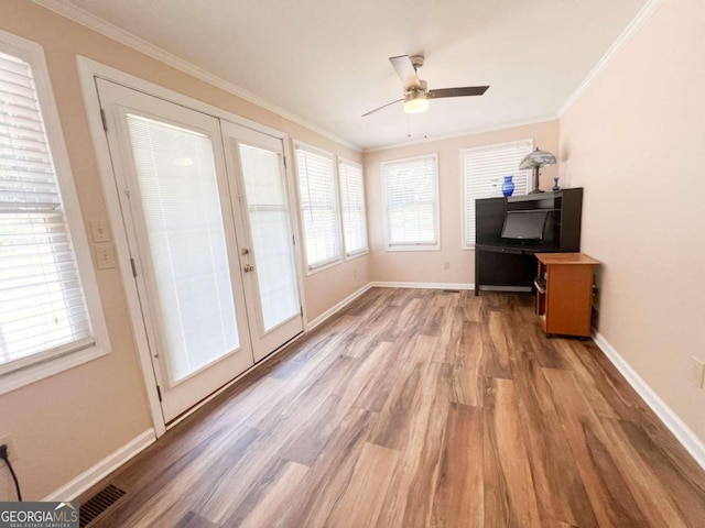 interior space with french doors, ceiling fan, hardwood / wood-style flooring, and ornamental molding