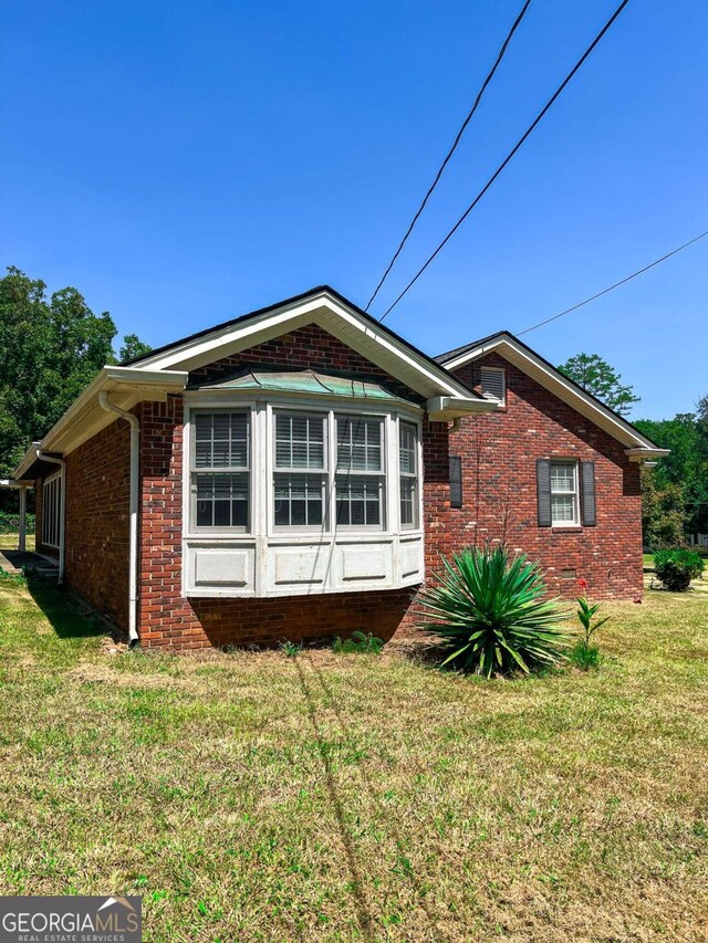 view of property exterior featuring a lawn