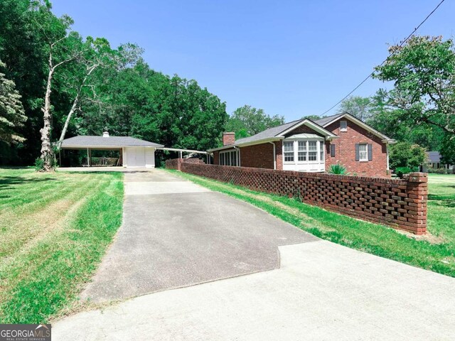 ranch-style house featuring driveway, a front lawn, and brick siding