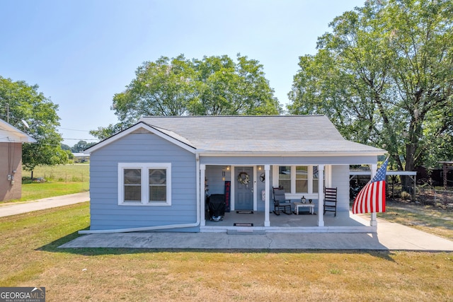 rear view of property with a yard