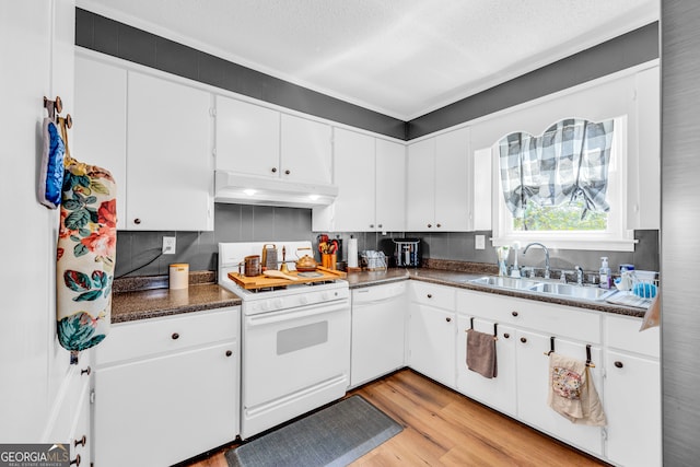 kitchen featuring sink, white appliances, white cabinetry, and light hardwood / wood-style floors