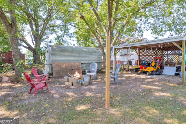 view of yard with an outdoor fire pit