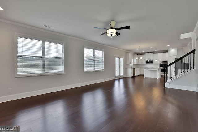 unfurnished living room featuring dark hardwood / wood-style flooring and crown molding