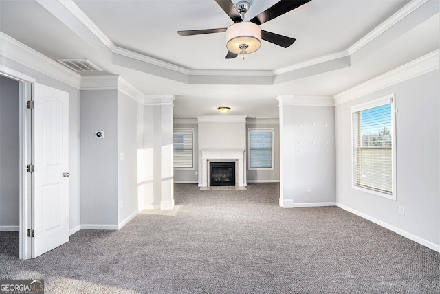 unfurnished living room with carpet, a raised ceiling, and ornamental molding