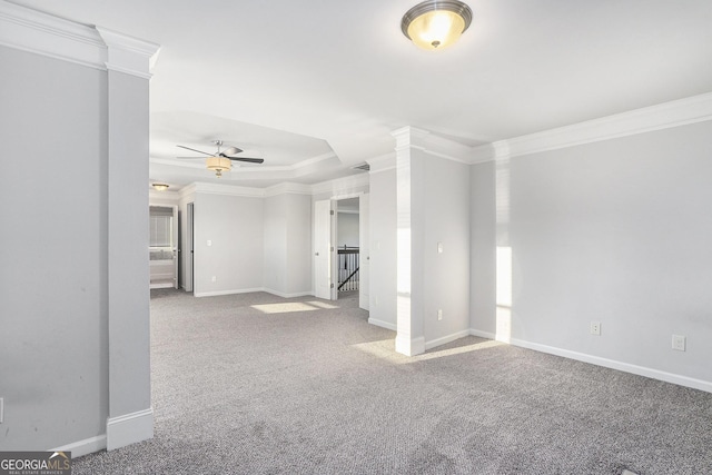 carpeted empty room with ceiling fan and ornamental molding