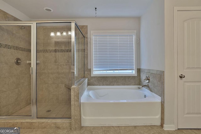 bathroom featuring tile patterned flooring and independent shower and bath