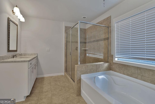 bathroom with tile patterned flooring, vanity, and separate shower and tub