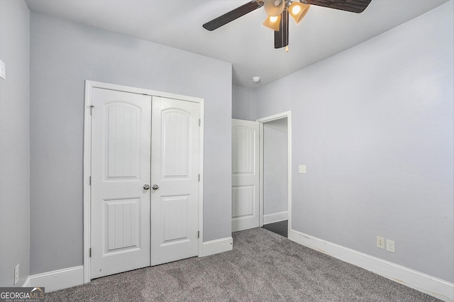 unfurnished bedroom with carpet flooring, ceiling fan, and a closet