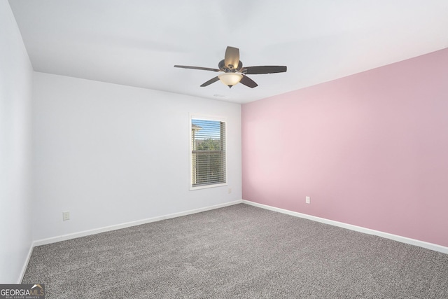 carpeted spare room featuring ceiling fan