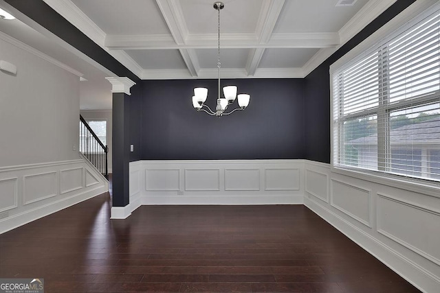 unfurnished dining area featuring beam ceiling, coffered ceiling, a chandelier, and dark hardwood / wood-style floors