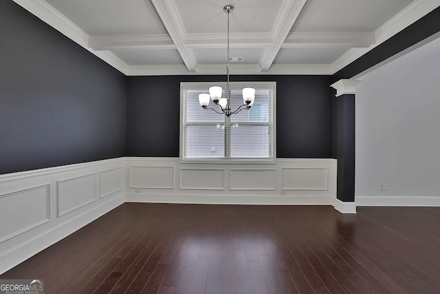 unfurnished dining area featuring beamed ceiling, dark hardwood / wood-style floors, coffered ceiling, and an inviting chandelier