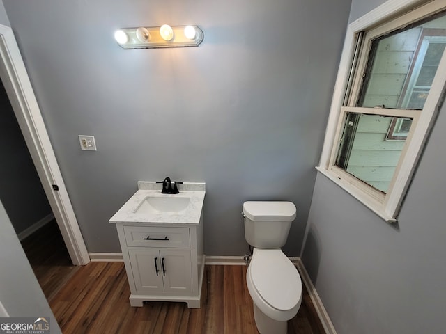 bathroom featuring vanity, toilet, and hardwood / wood-style floors