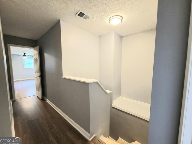 interior space featuring dark hardwood / wood-style flooring and a textured ceiling