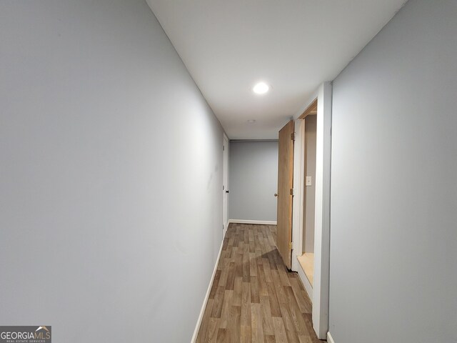 corridor with light wood-type flooring