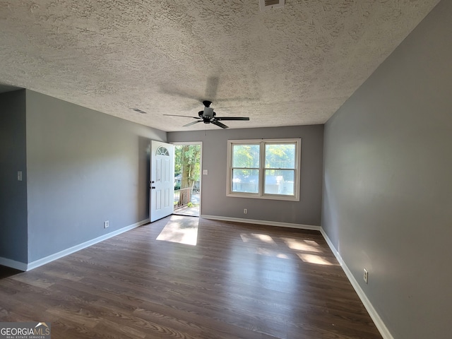 unfurnished room featuring a textured ceiling, ceiling fan, and dark hardwood / wood-style floors