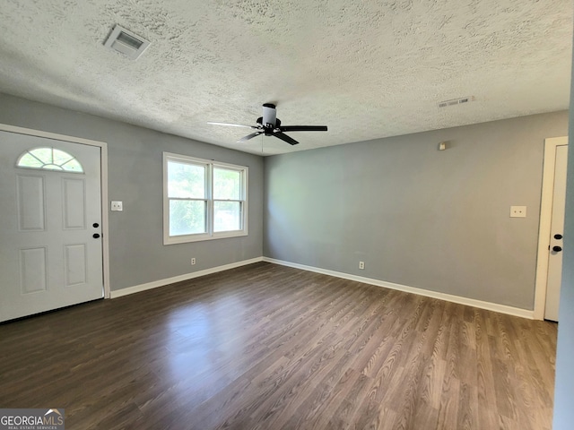 entrance foyer with dark wood-type flooring, ceiling fan, and a textured ceiling