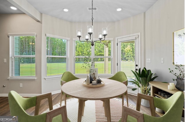 dining space featuring a chandelier, visible vents, recessed lighting, and wood finished floors