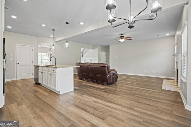 living area with visible vents, stairs, baseboards, and wood finished floors