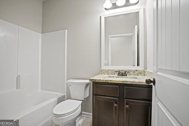 bathroom featuring bathing tub / shower combination, toilet, and vanity