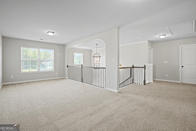 unfurnished room featuring attic access, carpet, baseboards, and visible vents