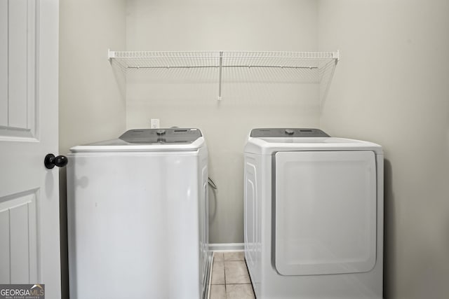 laundry room featuring washer and dryer, laundry area, and light tile patterned floors