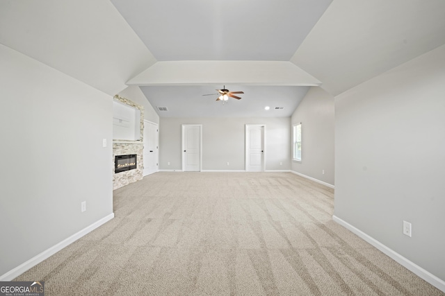 unfurnished living room with baseboards, light colored carpet, and vaulted ceiling