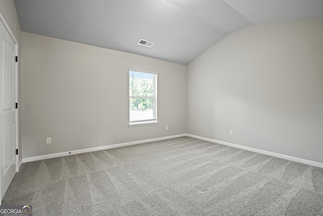 unfurnished room featuring lofted ceiling, carpet flooring, baseboards, and visible vents