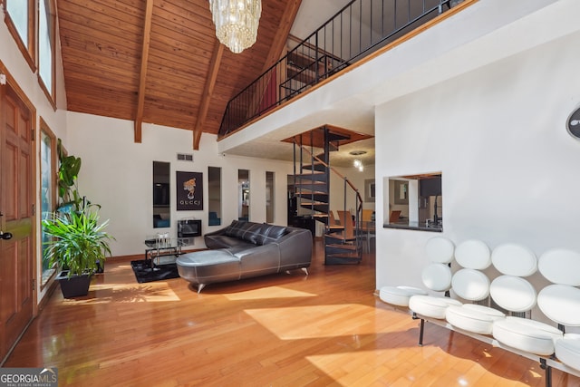 living room with beam ceiling, a chandelier, high vaulted ceiling, wooden ceiling, and hardwood / wood-style floors