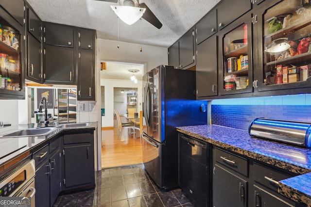 kitchen featuring decorative backsplash, dark tile patterned flooring, stainless steel appliances, a textured ceiling, and ceiling fan