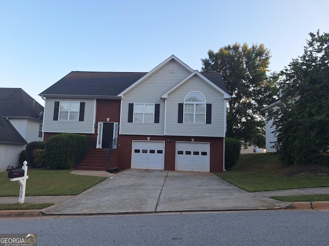 raised ranch featuring a front yard and a garage