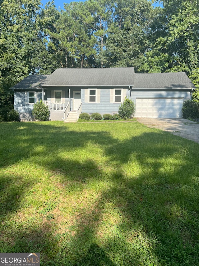 ranch-style home featuring a porch, a garage, and a front lawn