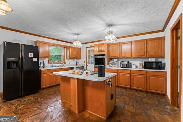 kitchen featuring a notable chandelier, black appliances, pendant lighting, a kitchen island, and a textured ceiling