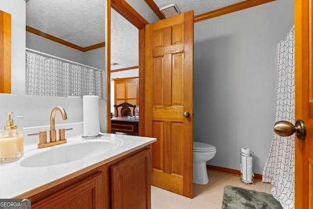 bathroom featuring a textured ceiling, vanity, toilet, ornamental molding, and tile patterned floors