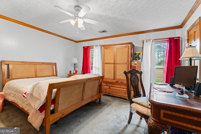 carpeted bedroom featuring ornamental molding, multiple windows, a textured ceiling, and ceiling fan