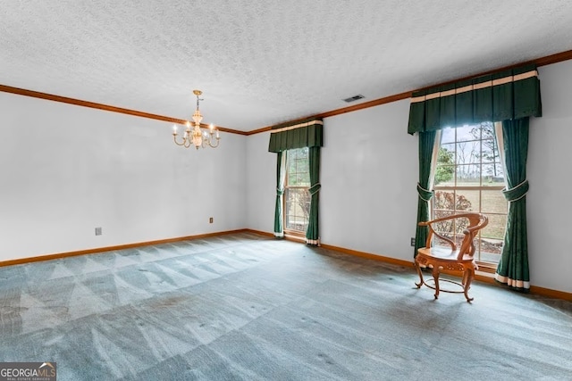 empty room featuring a textured ceiling, carpet flooring, and a notable chandelier