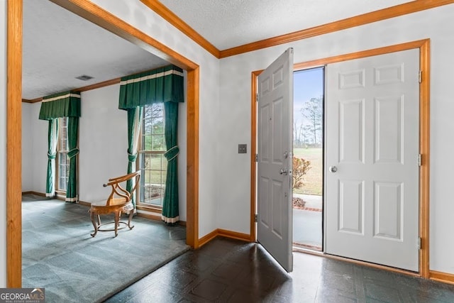 entrance foyer with carpet floors, crown molding, and a textured ceiling