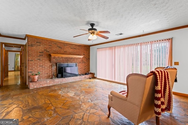 unfurnished living room with a textured ceiling, ceiling fan, ornamental molding, and a fireplace