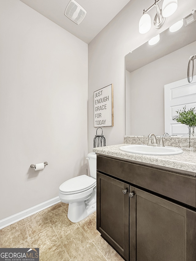 bathroom with tile patterned floors, toilet, and vanity