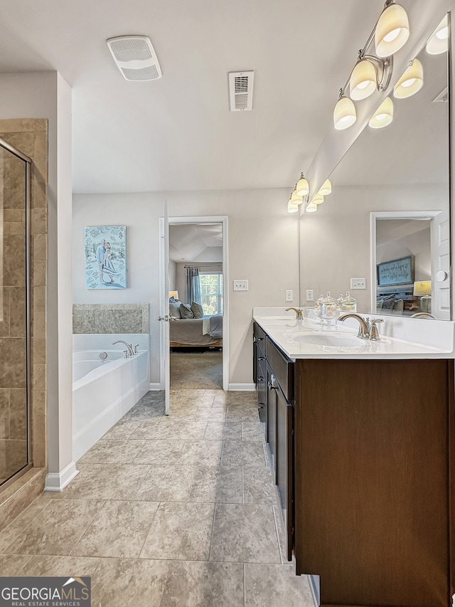 bathroom featuring vanity and independent shower and bath