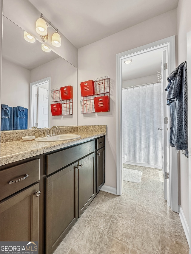 bathroom with walk in shower and vanity